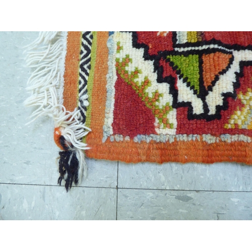 261 - Rugs: to include an Afghan example with geometric motifs, on an orange ground  39