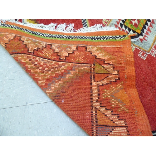 261 - Rugs: to include an Afghan example with geometric motifs, on an orange ground  39