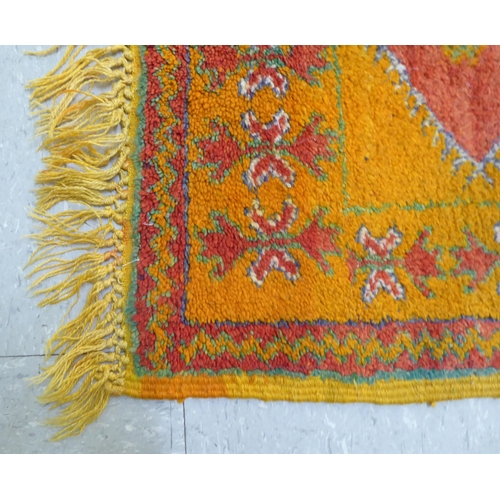 261 - Rugs: to include an Afghan example with geometric motifs, on an orange ground  39