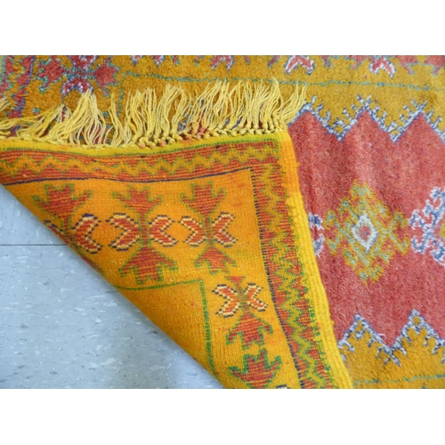 261 - Rugs: to include an Afghan example with geometric motifs, on an orange ground  39