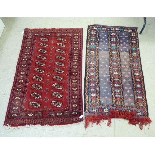 262 - Rugs: to include a Bokhara with elephant foot motifs, on a red ground  50