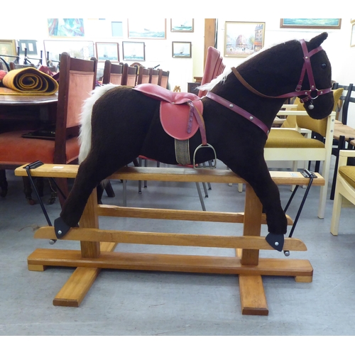 265 - A Pegasus fur fabric rocking horse, on a stained beech stand  39