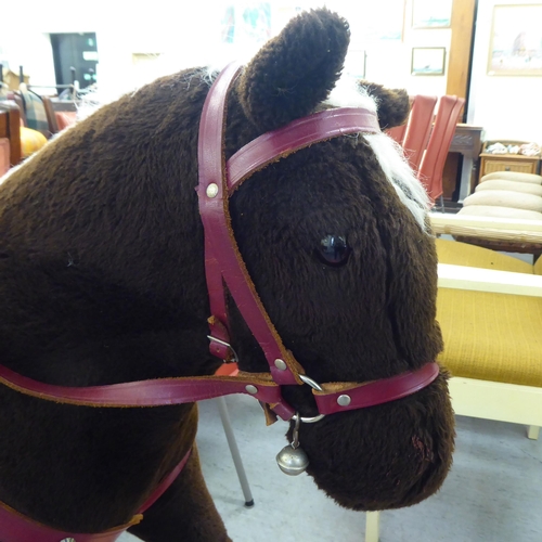 265 - A Pegasus fur fabric rocking horse, on a stained beech stand  39