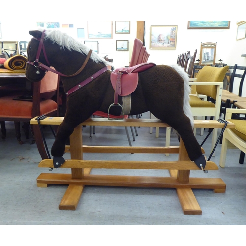 265 - A Pegasus fur fabric rocking horse, on a stained beech stand  39