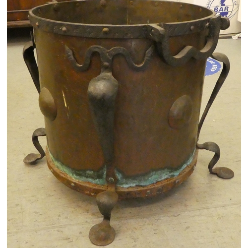 279 - An Arts & Crafts period cast and wrought iron bound, rivetted copper coal bin, raised on splayed... 