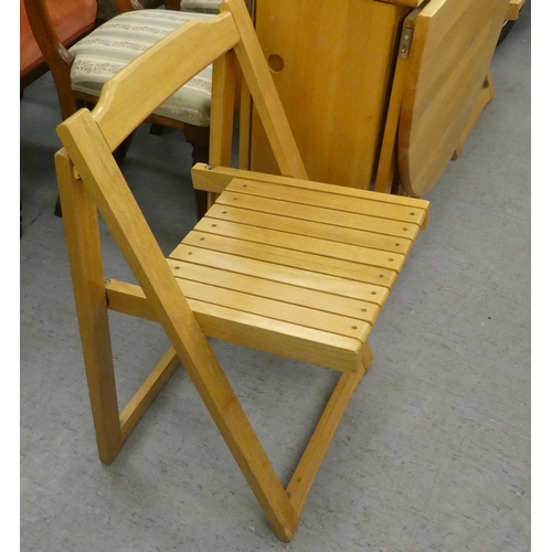 28 - A modern beech drop-leaf dining table, raised on block feet  30