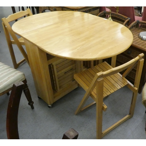 28 - A modern beech drop-leaf dining table, raised on block feet  30