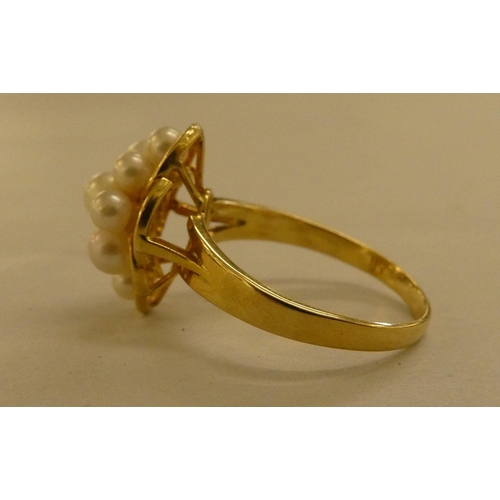 297 - Jewellery: to include an 18ct gold ring, set with seed pearls and two diamond chips 