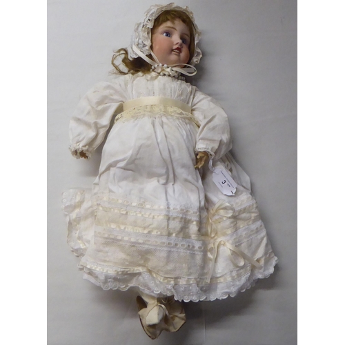 3 - An early 20thC Verlingue Petite Francais bisque head doll with painted features, on a jointed compos... 