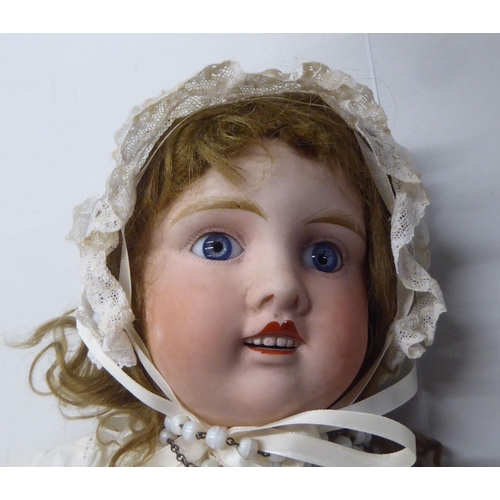 3 - An early 20thC Verlingue Petite Francais bisque head doll with painted features, on a jointed compos... 