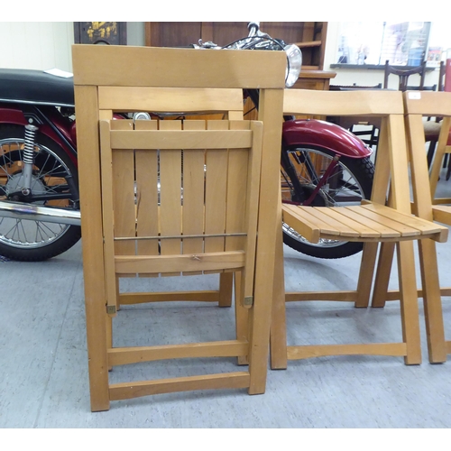 30 - A set of four modern folding beech framed chairs