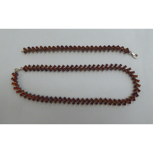 302 - A silver bracelet, set with amber coloured beads; and a matching necklace