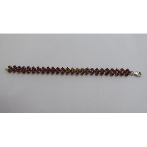 302 - A silver bracelet, set with amber coloured beads; and a matching necklace