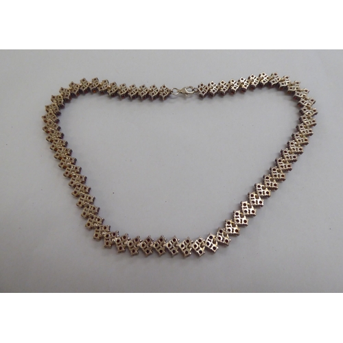 302 - A silver bracelet, set with amber coloured beads; and a matching necklace