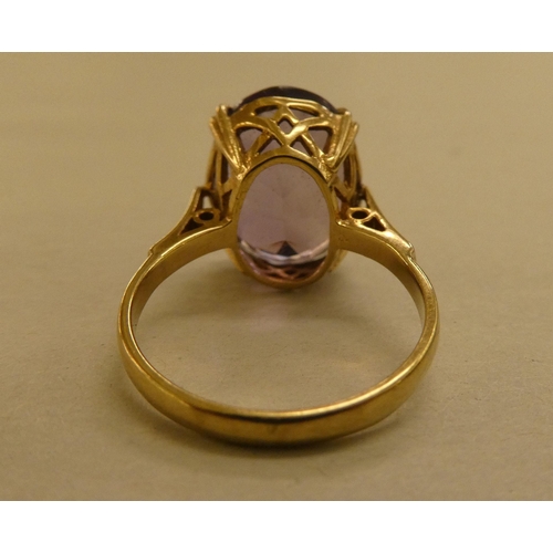 305 - A 9ct gold ring, set with a light purple coloured stone