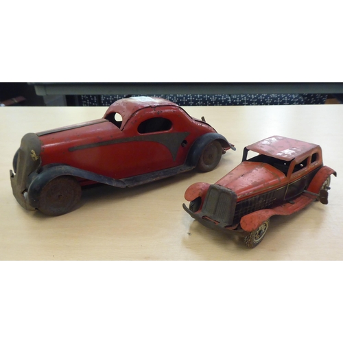 312 - Two British made, painted tinplate, vintage clockwork operated toy cars