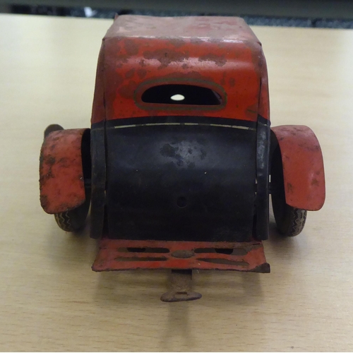 312 - Two British made, painted tinplate, vintage clockwork operated toy cars