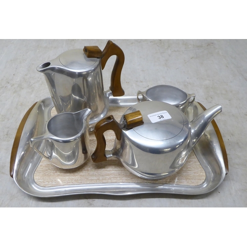 38 - A five piece Picquot Ware tea set, comprising a tray  17