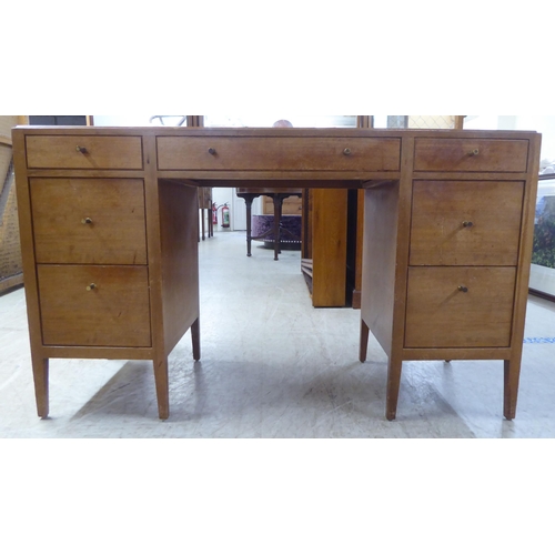 48 - A 1960s/1970s bleached mahogany seven drawer dressing table, surmounted by a triptych mirror  5... 