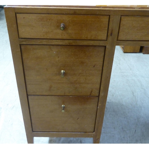 48 - A 1960s/1970s bleached mahogany seven drawer dressing table, surmounted by a triptych mirror  5... 