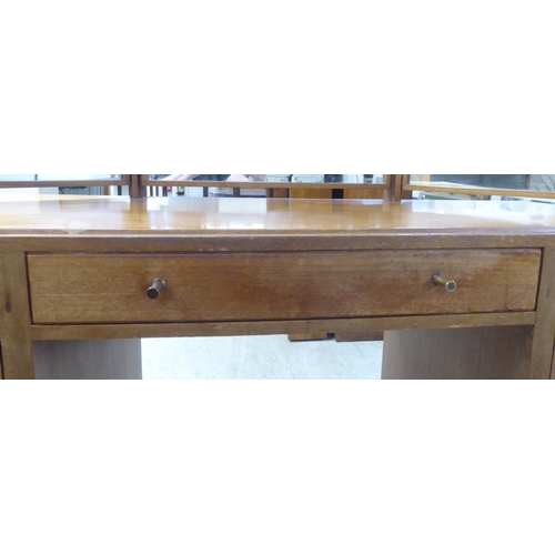 48 - A 1960s/1970s bleached mahogany seven drawer dressing table, surmounted by a triptych mirror  5... 