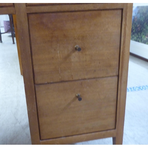 48 - A 1960s/1970s bleached mahogany seven drawer dressing table, surmounted by a triptych mirror  5... 