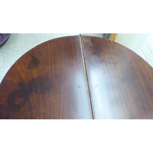 51 - A George III mahogany demi-lune tea table, the hinged top raised on square, tapered legs  28