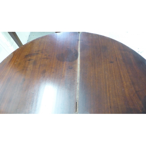 51 - A George III mahogany demi-lune tea table, the hinged top raised on square, tapered legs  28