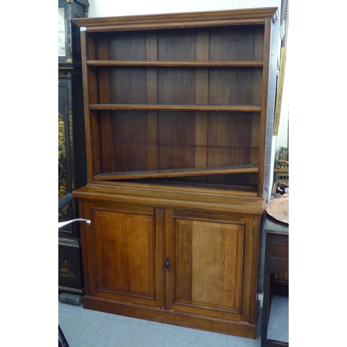 55 - An Edwardian mahogany cabinet bookcase, the superstructure with three open shelves, over a pair of p... 