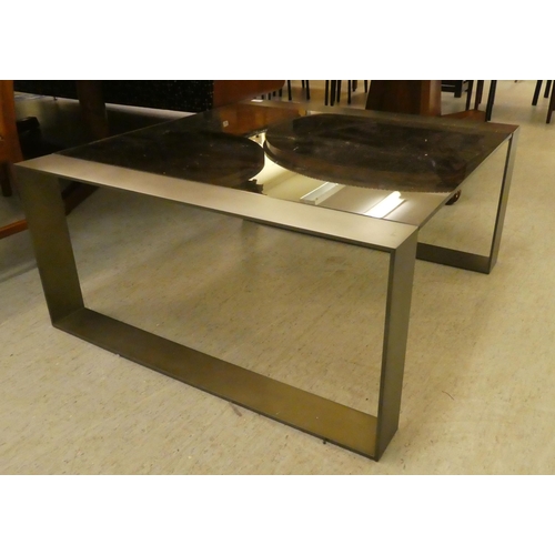 59 - A modern burnished bronze coloured, steel framed coffee table with smoked glass top  17