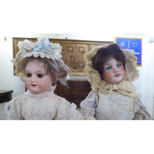 6 - Three bisque head dolls: to include an early 20thC example with painted features, on a jointed compo... 