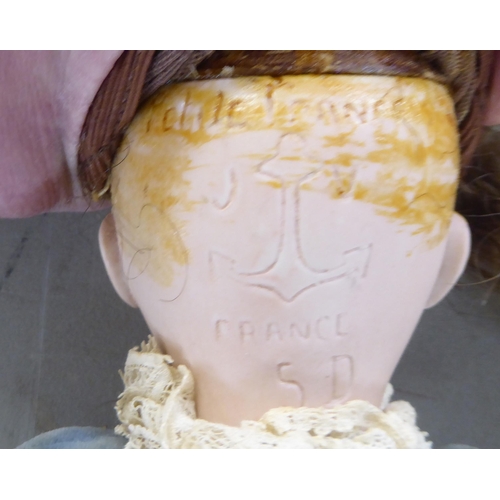 7 - Dolls: to include an early 20thC Armand Marseille bisque head example with painted features, on a jo... 