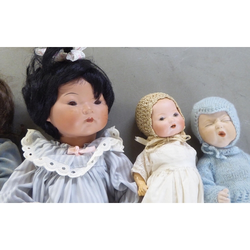 7 - Dolls: to include an early 20thC Armand Marseille bisque head example with painted features, on a jo... 