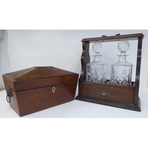 77 - A modern oak tantalus, accompanied by two glass decanters  12.5