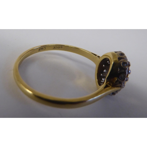 80 - An 18ct bi-coloured gold ring, set with a central yellow stone, surrounded by small diamonds