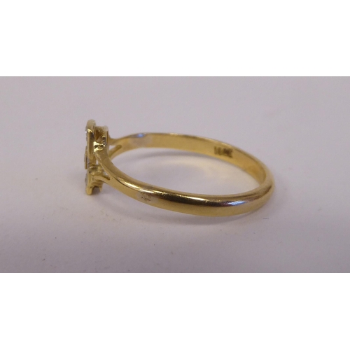 85 - A yellow metal ring, set with five diamonds, arranged on a central bar  stamped 18ct 