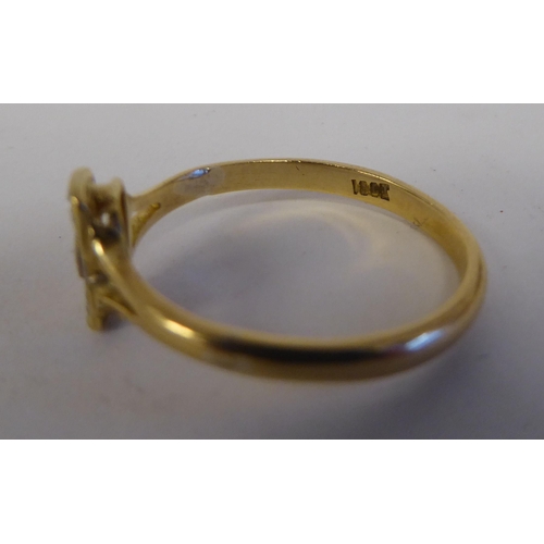 85 - A yellow metal ring, set with five diamonds, arranged on a central bar  stamped 18ct 