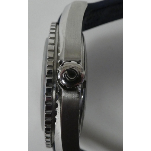 88 - A stainless steel and enamel cased automatic wristwatch, on a rubber strap 