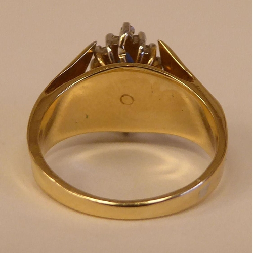 90 - A 14ct gold ring, set with a sapphire and diamond, surrounded by small claw set diamonds