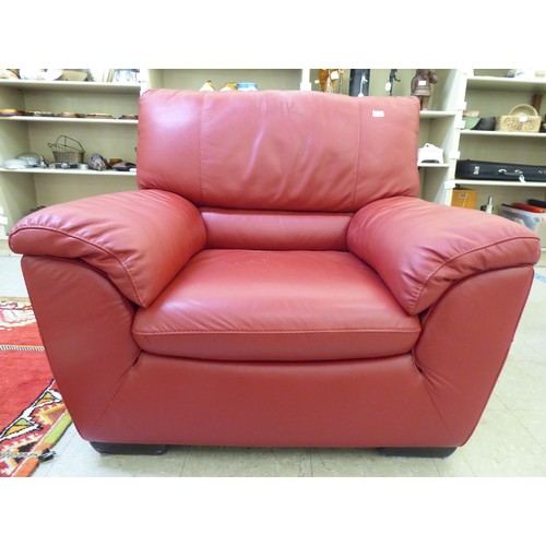 224 - A modern red faux hide upholstered armchair