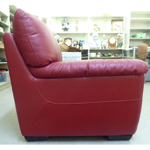 224 - A modern red faux hide upholstered armchair