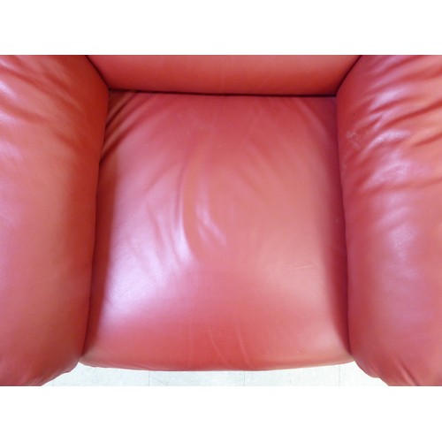 224 - A modern red faux hide upholstered armchair