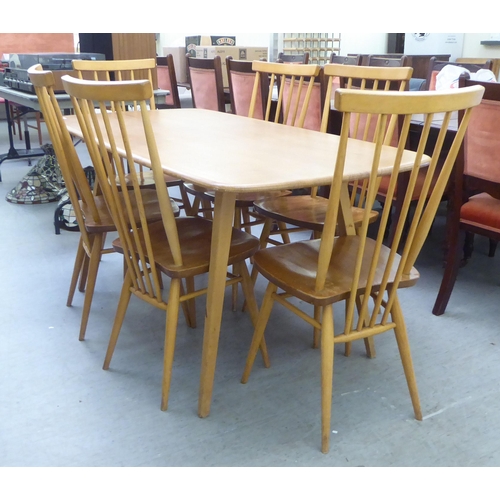 258 - An Ercol blonde elm dining table, raised on square, tapered legs  30