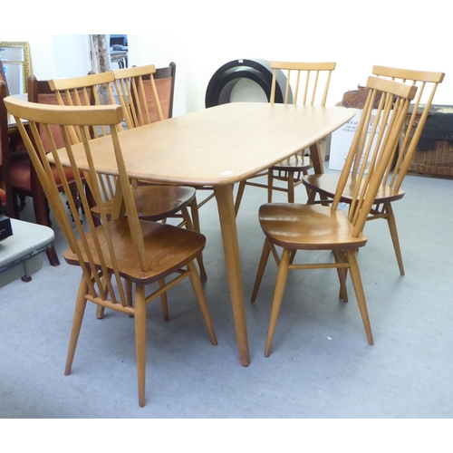 258 - An Ercol blonde elm dining table, raised on square, tapered legs  30