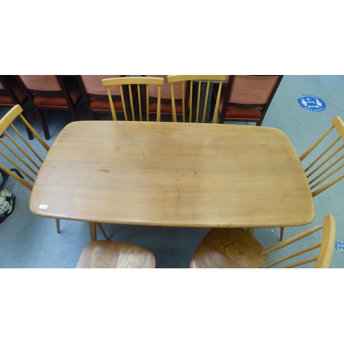 258 - An Ercol blonde elm dining table, raised on square, tapered legs  30