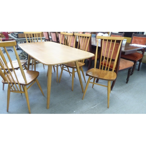 258 - An Ercol blonde elm dining table, raised on square, tapered legs  30