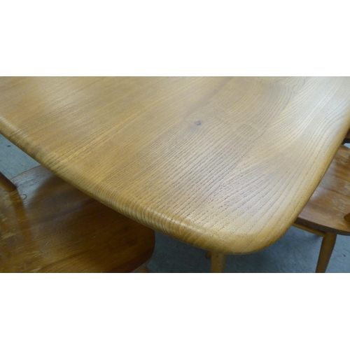 258 - An Ercol blonde elm dining table, raised on square, tapered legs  30