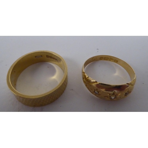 272 - An 18ct gold rubover set, three diamond ring; and an 18ct gold, textured band ring