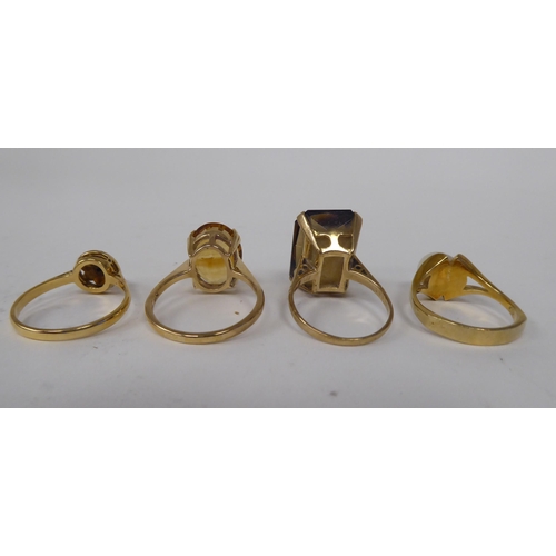 273 - Four various 9ct gold and other dress rings, one claw set with a citrine