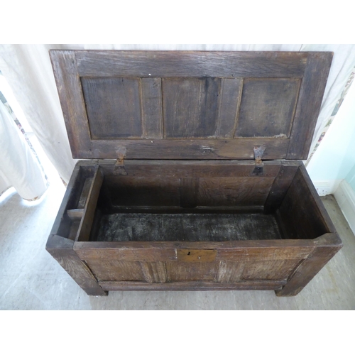 28 - An early 18thC oak coffer with straight sides and a hinged lid, on block feet  22